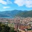 View of Lake Como, with a town below and a lake boarded my mountains. in the background.