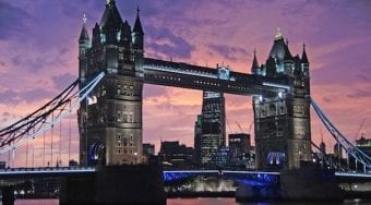 London bridge towers under a pink and purple sunset