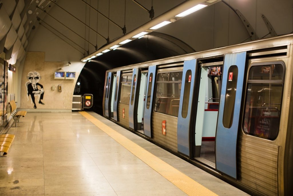 Lisbon airport metro train waiting on the platform. The journey by train from lisbon airport to sintra is budget friendly but takes more time than a taxi or private transfer and you'll have to change from the train to the metro line.