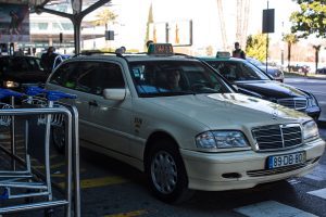 Lisbon airport taxis - welcome pickups Lisbon airport white and black taxis lined up. Take a taxi from Lisbon Airport to Cascais and start exploring.