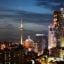 Tall buildings in Macau city center lit up at night.