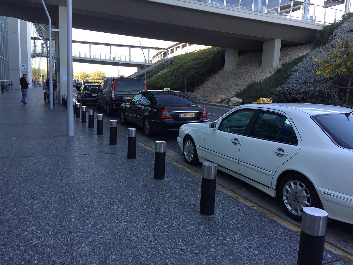 Larnaca airport black and white taxis waiting on the line