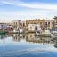 two story homes and boats line the waterway in Paros