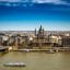St. Stephen's Basilica along the Danube River, flanked by the Szechenyi Chain Bridge, the riverside hotel, and the Budapest Eye Ferris Wheel, all popular destinations in Budapest.