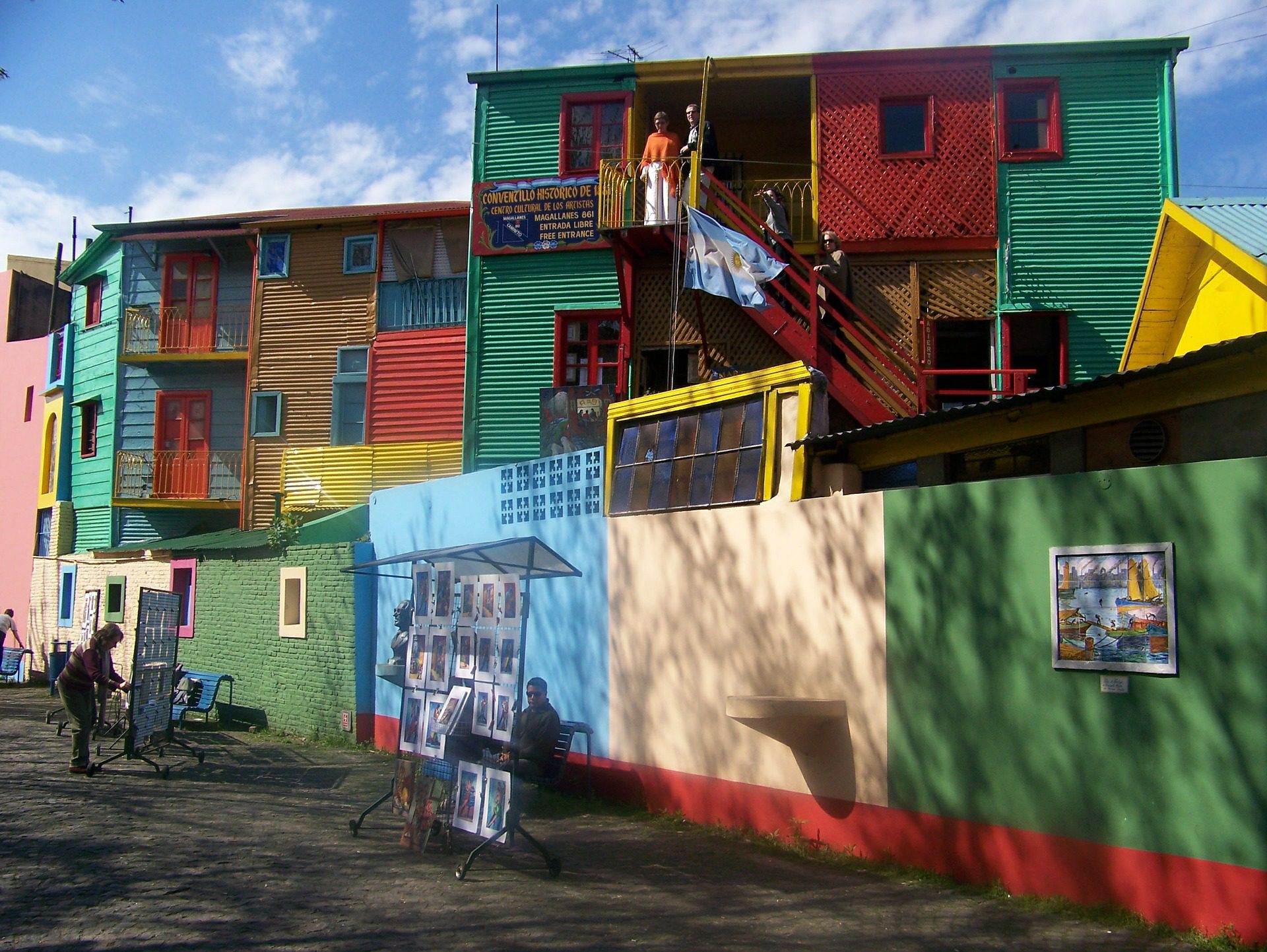 homes painted with primary colors in squares under a blue sky