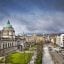 iconic belfast buildings and walkways under a blue cloudy sky