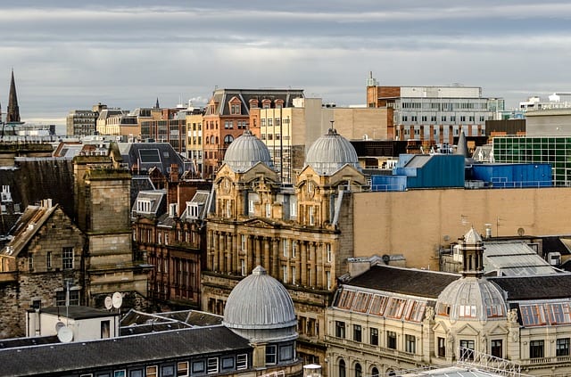 A view of Glasgow's city center filled with a blend of modern and historical buildings.