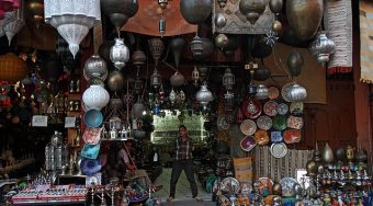 A busy market in Marrakech, Morocco, displays handmade lamps.