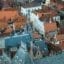 A birds-eye view of gray and terracotta-colored rooftops in Bruges.