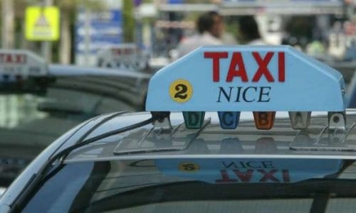 A white taxi rood sign reading 