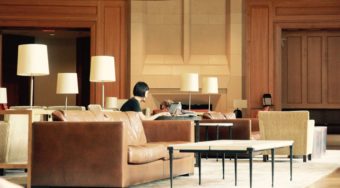 woman working on laptop in hotel lobby
