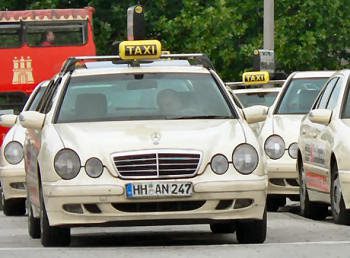 unnamed (1) A line of beige taxis in Stuttgart with yellow taxi sign on the roof.