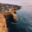orange cliffs alongside dark blue waters of San Diego shores