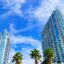 high rise buildings with balconies against a blue sky with a few thin white clouds