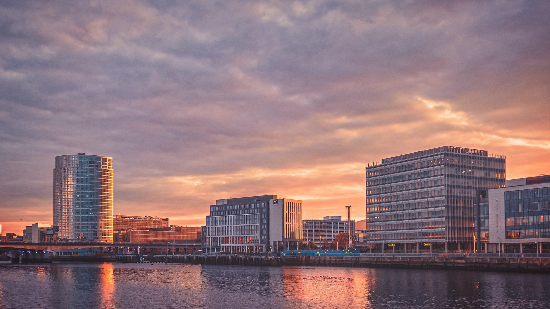 purple and orange sunset over Belfast city buildings and waterways