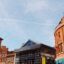 iconic orange and teal buildings under a white sky in Belfast