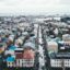 aerial view of colourful houses and other city buildings in Reykjavik under a cloudy sky in daytime