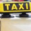 white cab roof with a yellow and black 'taxi' sign