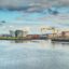 waterfront under a cloudy sky in front of Belfast buildings