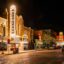 city buildings at night time, with flashy lights, neon signs