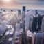 dramatic drone view of the city skyline with white and dark grey high-rise buildings in the spotlight