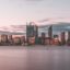 Perth city skyline near a body of water shot just after sunset. Take a Perth airport taxi and start exploring right away.