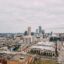 aerial shot of city buildings under a cloudy sky in daytime