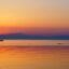 sea shot during golden hour with a little boat sailing