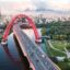 red cable-stayed bridge spanning Moskva River with bold colours in daytime