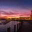lighted parliament buildings situated by body of water and photographed after golden hour
