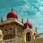 mysore palace in india under a blue sky with sparse white clouds