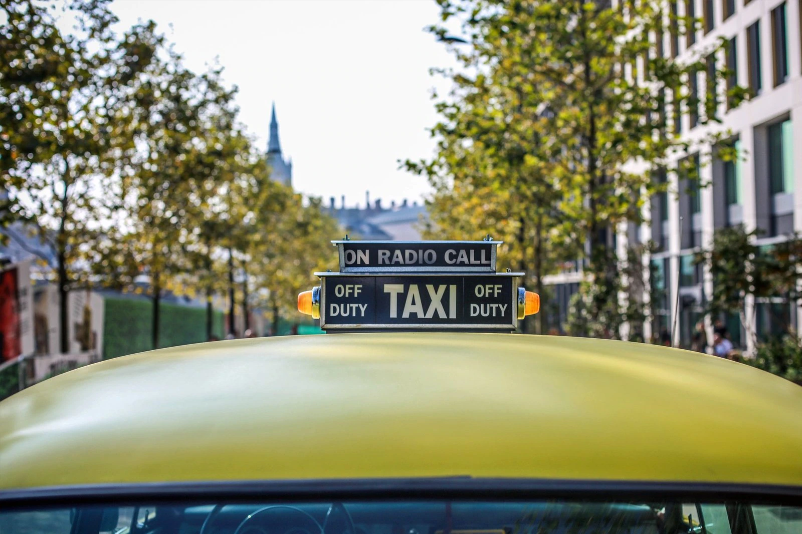 Ottawa taxi yellow taxi roof with signature taxi sign reading on radio call and off duty photographed in daytime