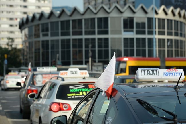 taxis with signature roof signage in the streets of Warsaw