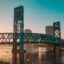 bridge over body of water photographed during golden hour
