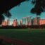 golden hour photo of city buildings, tree silhouettes and green grass under a blue sky inMakati City, Philippines
