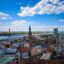 Authentic, old, colourful city buildings in the heart of Riga photographed from above, under a blue sky with sparse white clouds.
