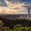 sun appearing behind clouds in the sky over the Taipei city centre