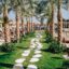 palm tree lined path in a Hurghada family resort during the daytime
