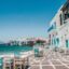 Little Venice area in Mykonos, white houses and tables with chairs by the sea