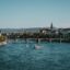 body of water with a bridge at a distance under a blue sky