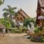 dragon statues and green trees around traditional buildings in daytime