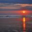 Sunset at a beach in Seminyak with the waves hitting the shore.