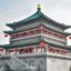 bell tower photographed in daytime with traditional red lanterns