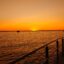 Sunset view from a dock by the sea.