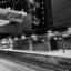 black and gray shot of a train station platform