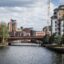 cloudy sky above the city's river, a bridge and modern flat houses