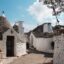 whitewashed brick homes under a cloudy sky