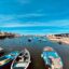 Small blue boats floating around in Bari