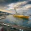 shot of a large yellow and white ferry under a cloudy sky in daytime