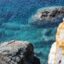 shot focusing on part of the blue sea waters and grey rock formations
